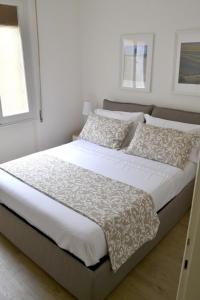 A bed or beds in a room at Modarno Exclusive Apartments