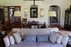 a living room with a white couch with pillows at Monte dos Papa Figos in São Teotónio