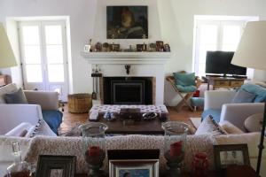 a living room with a couch and a fireplace at Monte dos Papa Figos in São Teotónio