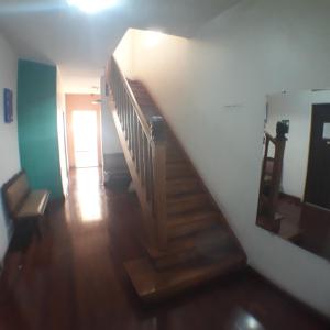 a hallway with a wooden staircase and a stair case at Hotel Pousada Clínicas Valente in São Paulo