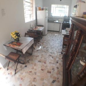 a kitchen with a table and chairs and a refrigerator at Hotel Pousada Clínicas Valente in São Paulo