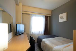 Voodi või voodid majutusasutuse Hotel Binario Umeda toas
