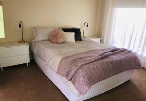 a bedroom with a large bed and a window at Villa Asolana in Myrtleford