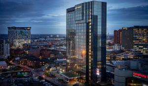 a tall glass skyscraper in a city at night at Hyatt Regency Birmingham in Birmingham