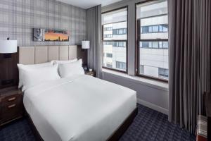 a bedroom with a large white bed and a window at Hyatt Centric Faneuil Hall Boston in Boston +17 photos