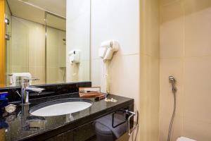 a bathroom with a sink, toilet, and mirror at Ibis Mall Of The Emirates in Dubai