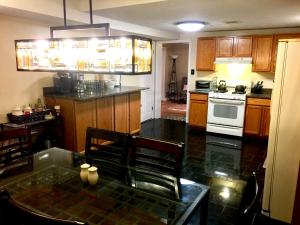 a kitchen with a table and a stove top oven at The Haven at Charity House in Waldorf