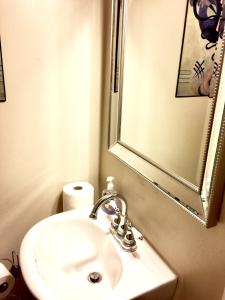 a bathroom with a white sink and a mirror at The Haven at Charity House in Waldorf