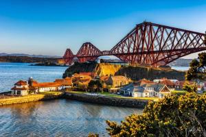 a bridge over a town next to the water at Park Road Holiday Home in Rosyth