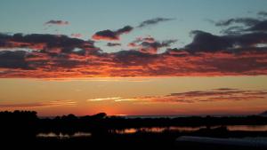 a sunset over a body of water with the sky at Casa Noemi in Sperlonga