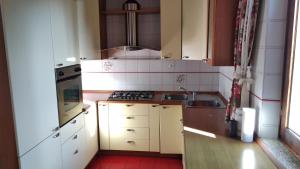 a small kitchen with a sink and a stove at VILLA MERY in Torri del Benaco