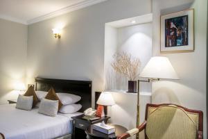 Llit o llits en una habitació de Hotel Sarina