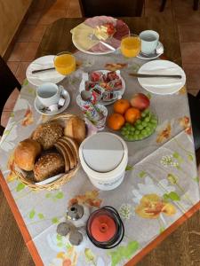 a table topped with breakfast foods and orange juice at Hotel Montag in Sankt Goar