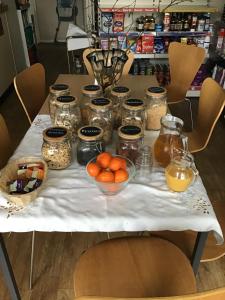 a table with jars and bowls of food on it at The Hub at Abercrave in Abercraf