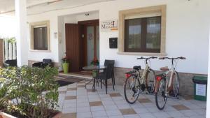 two bikes parked on the outside of a house at Messapia in Oria