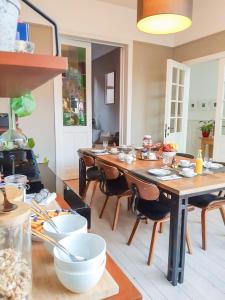 a kitchen with a long wooden table with chairs at Domus Portus in Dendermonde +31 photos