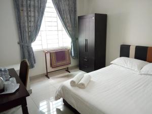 Postel nebo postele na pokoji v ubytování Hotel Mutiara KGMMB, Melaka
