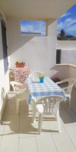 a white table and chairs on a patio at Villa Sunshine in Triscina