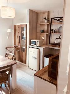 a kitchen with a white refrigerator and a microwave at L'Oisette in Ghislenghien