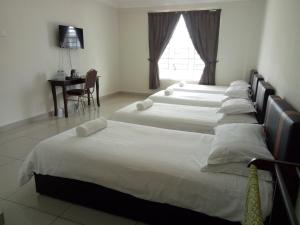 Postel nebo postele na pokoji v ubytování Hotel Mutiara KGMMB, Melaka