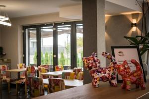 a toy dog sitting on a table in a restaurant at Axel Boutique Jacuzzi & Sauna in Dziwnów