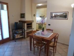 グレーヴェ・イン・キアンティにあるLa Casina Appartamento nel Cuore di Greve in Chiantiのキッチン(テーブル、椅子、テーブル、テレビ付) +15枚の写真