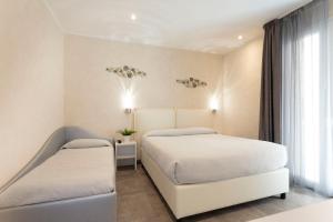 Posteľ alebo postele v izbe v ubytovaní White Suite & Apartments