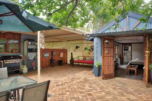 a room with a patio with a bed and a table at Rivershack Pet Friendly in Renmark