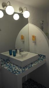 a bathroom with a sink and a mirror at Casa de la Mare in Vama Veche