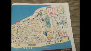 a map of a city on a book at Spacious modern and cozy apartment in Trapani