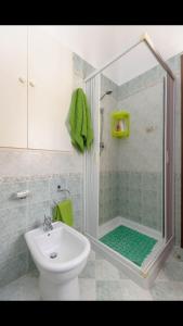 a bathroom with a shower and a toilet and a sink at Spacious modern and cozy apartment in Trapani +11 photos