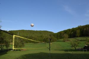 a volleyball net in a field with a ball in the air at A&M studio apartman in Otočac