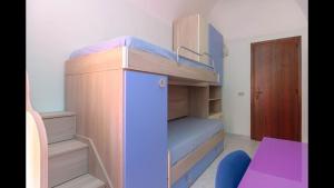 a small room with a bunk bed and a desk at Spacious modern and cozy apartment in Trapani