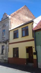 a yellow house with a brown roof at City Center AP 2 in Košice