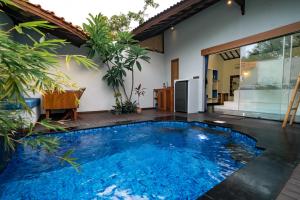 a swimming pool in the middle of a house at Stay Shark Villas Gili Air in Gili Islands