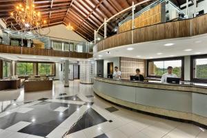 a lobby of a hotel with two people working at Capivari Ecoresort in Campina Grande do Sul