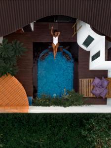 a model of a woman sitting on top of a swimming pool at Stay Shark Villas Gili Air in Gili Islands