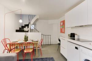 a kitchen and dining room with a table and chairs at Charming House for 6 people - Louvre & Opera in Paris