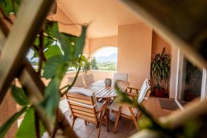 a table and chairs in a room with a balcony at Neretva Valley Apartments - Heated Pool in Metković