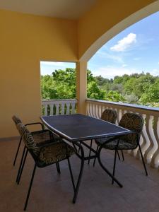 a black table and chairs on a balcony at Apartments Zdenka in Starigrad-Paklenica