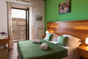 a bedroom with a bed with two towels on it at Murat Guesthouse in Pizzo