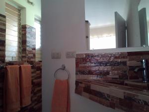 a bathroom with a red towel hanging on a wall at Domaine Vista Linda La casita del Loma Vista Mar in Río San Juan