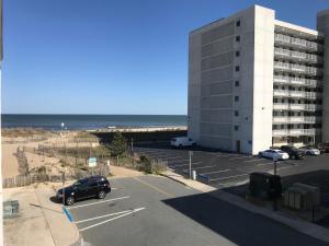 a parking lot with a building and the beach at Simple Life Motel in Ocean City