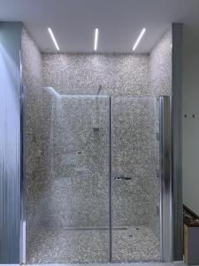 a shower with a glass door in a bathroom at Hotel Sila in Camigliatello Silano