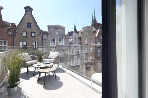a balcony with a view of a city at My Regina in Gdańsk