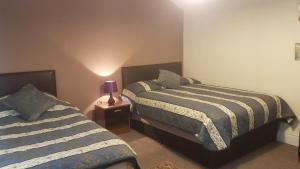 Postel nebo postele na pokoji v ubytování Arman Lodge House