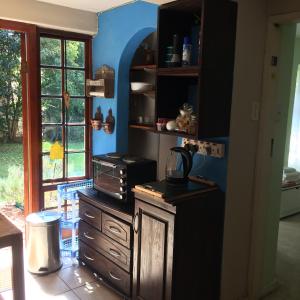 a kitchen with a counter with a stove and a window at Air on Edward in Pretoria