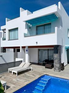 a villa with a swimming pool and a house at Luxury Villa in Los Cristianos in Arona