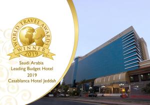 a sign for a hotel in front of a building at Casablanca Hotel Jeddah in Jeddah
