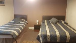 Postel nebo postele na pokoji v ubytování Arman Lodge House